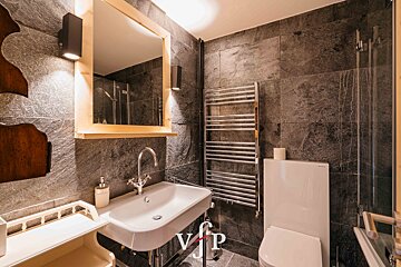 A bathroom with a sink and a toilet and a sign that says vip