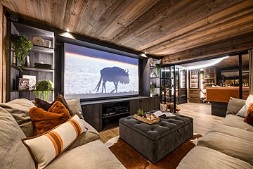 A living room with a projector screen showing a wildebeest