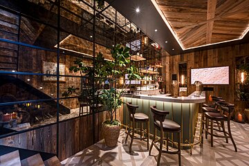 A bar with a plant in the middle of it