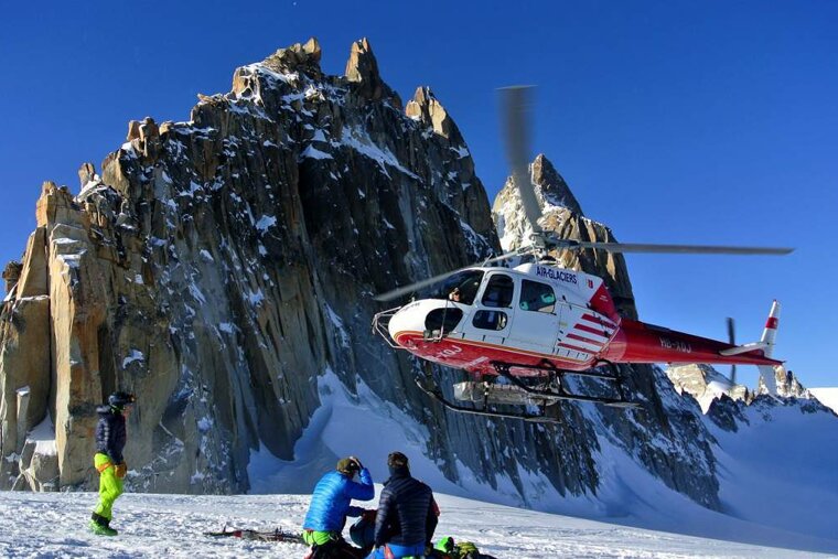 a helicopter landing on snow
