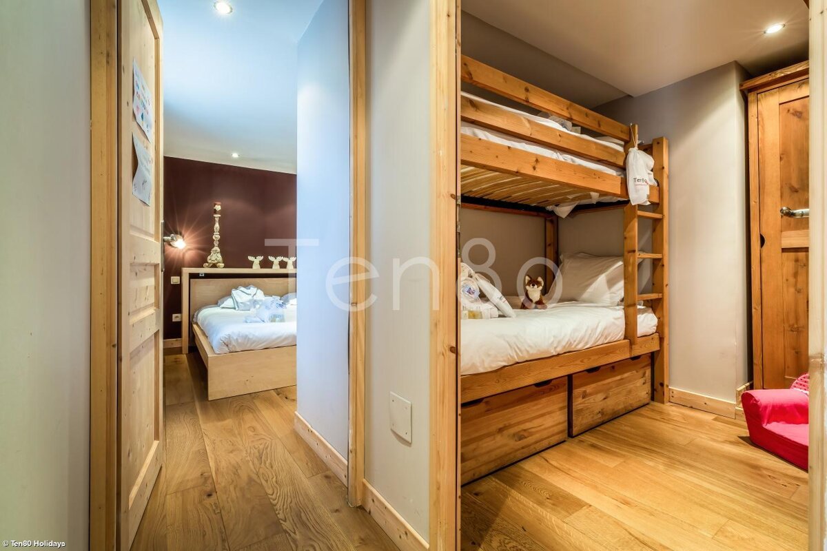 A bedroom with bunk beds and the word ten on the wall