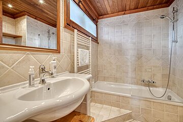 A bathroom with a sink a bathtub and a mirror