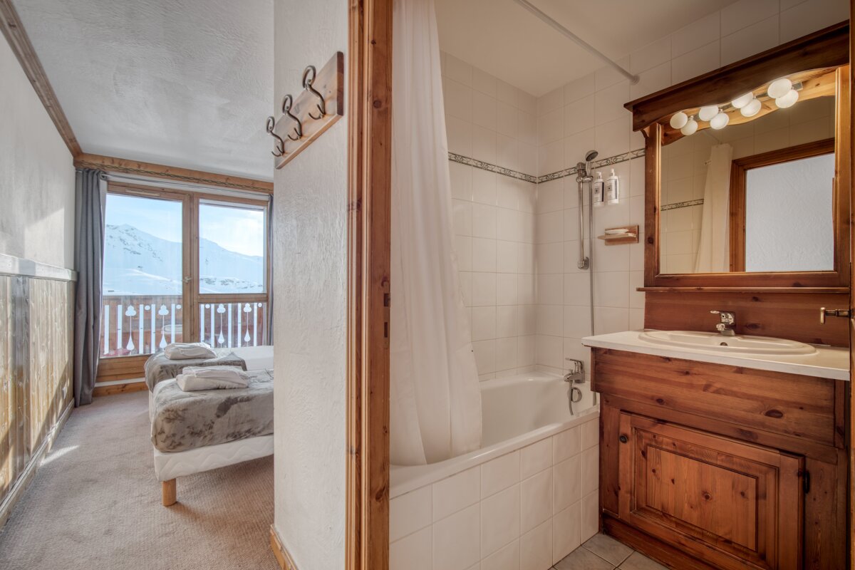 A bathroom with a bathtub a sink and a mirror