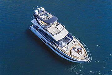 An aerial view of a yacht with people laying on the deck