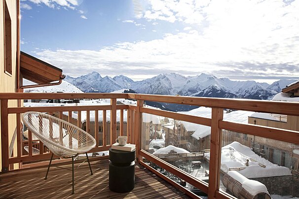 A balcony with a view of snow covered mountains