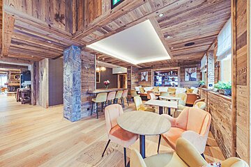 A room with wooden walls and tables and chairs