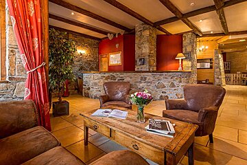 A table with a vase of flowers and a book on it that says 