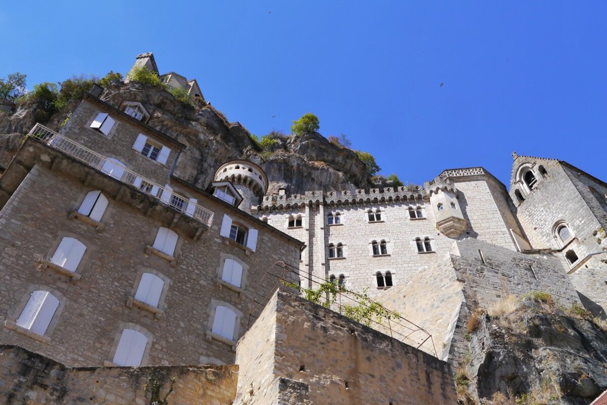 a view looking up at the religious buildings in rocamadour