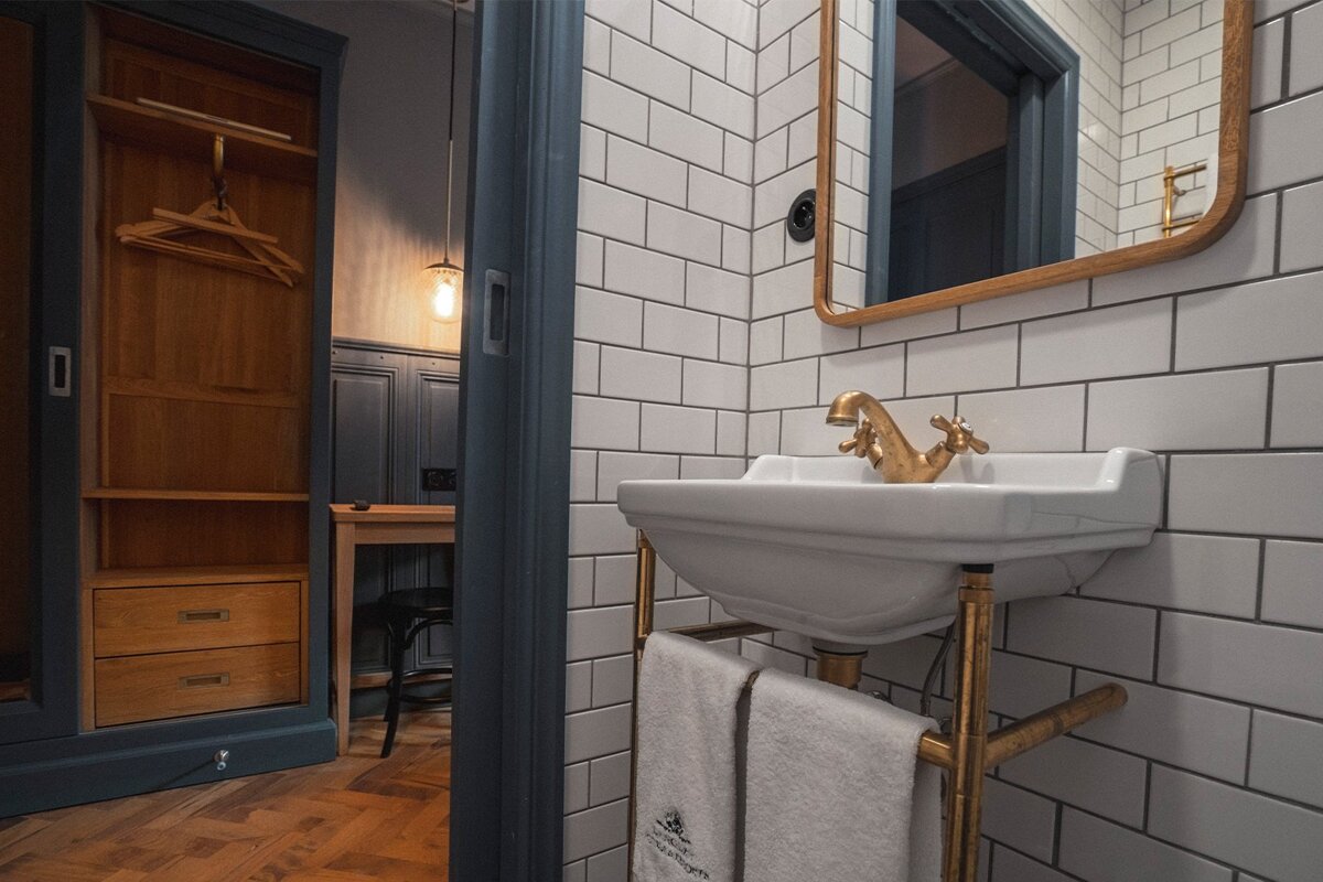 A bathroom with white subway tiles and a sink