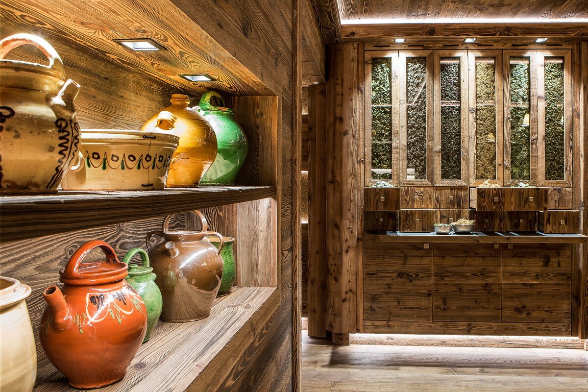 A row of ceramic pots on a wooden shelf one of which has the number 19 on it