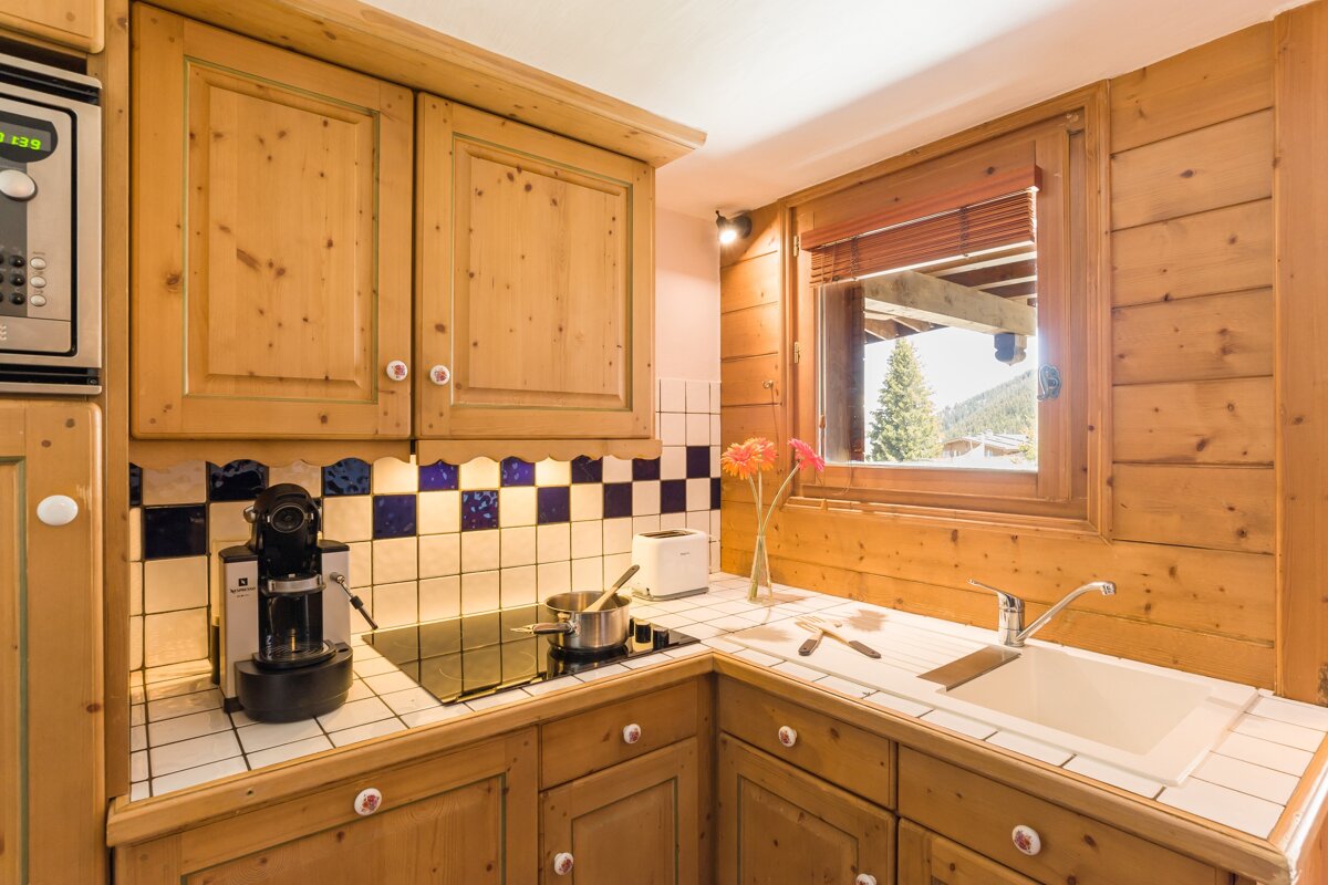 A kitchen with wooden cabinets and a nespresso machine