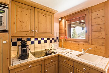 A kitchen with wooden cabinets and a nespresso machine