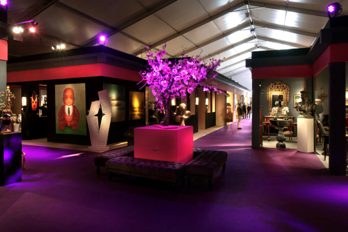 A room with purple lights and a tree in the middle