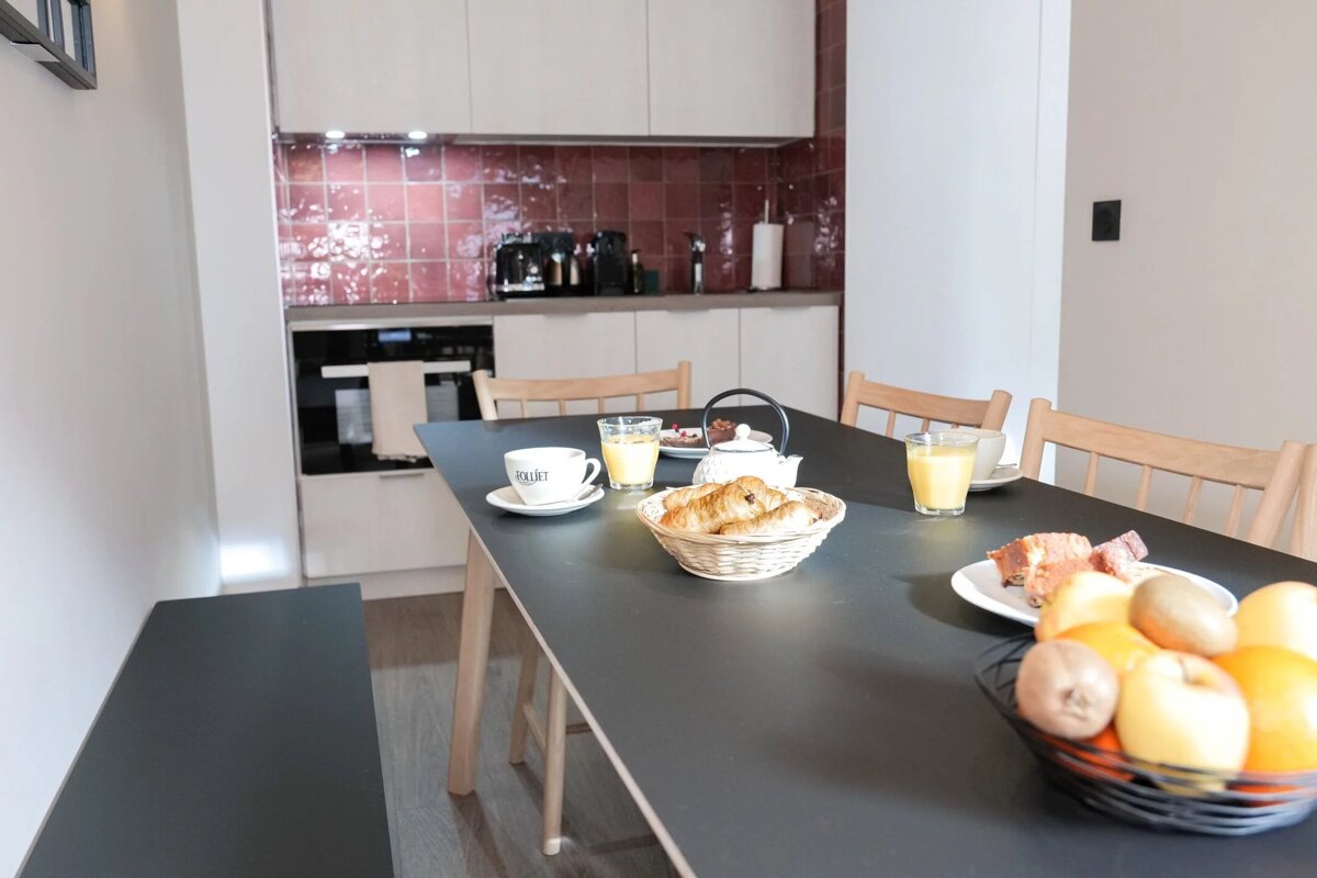 A black table with a basket of bread on it