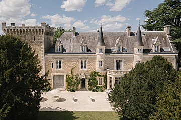 An aerial view of a large castle surrounded by trees
