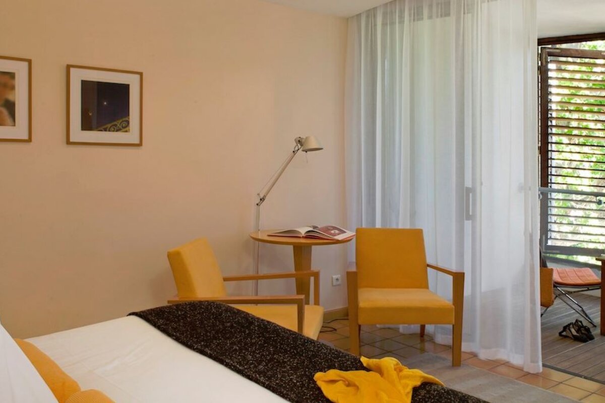 Double room with yellow chairs and internal balcony