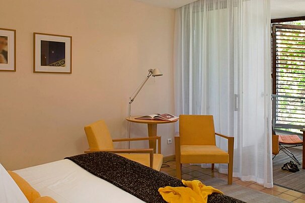 Double room with yellow chairs and internal balcony
