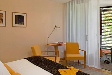 Double room with yellow chairs and internal balcony