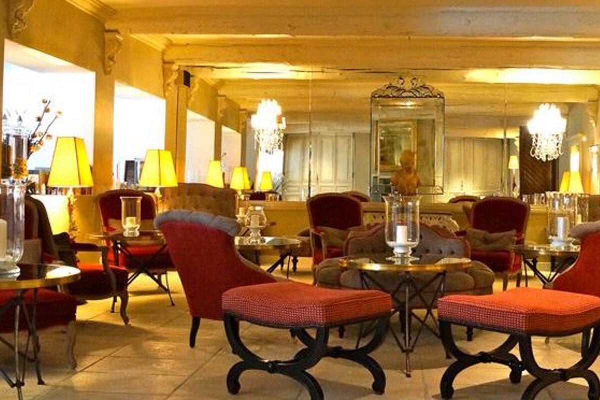 Bar with red and brown antique chairs and chanderliers