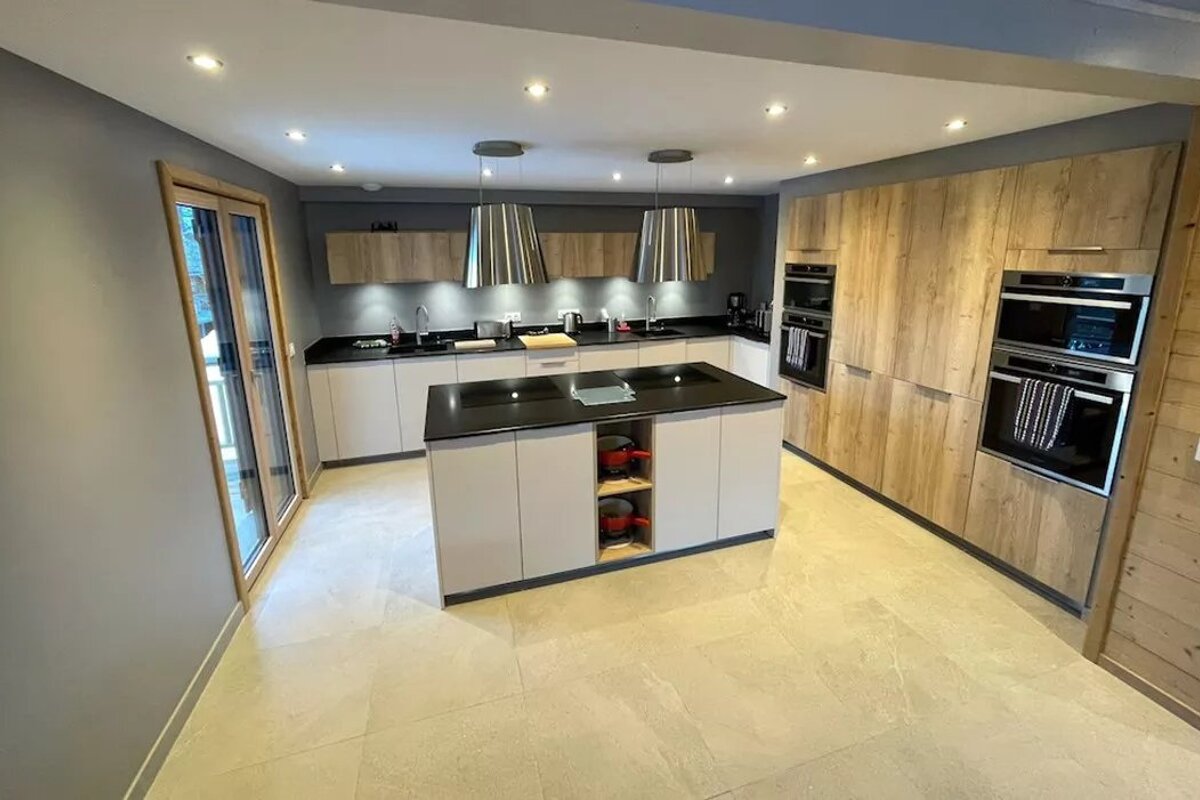 A kitchen with wooden cabinets and stainless steel appliances