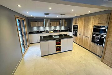 A kitchen with wooden cabinets and stainless steel appliances