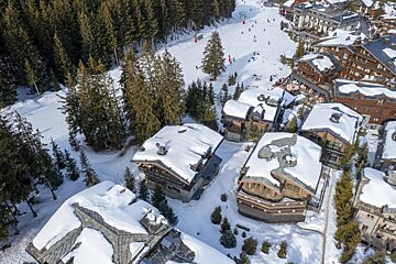 An aerial view of snow covered buildings in a ski resort