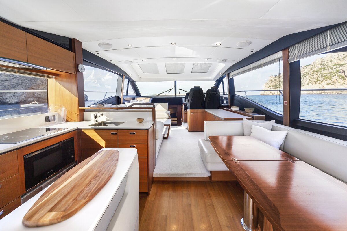 The inside of a boat with a wooden table and couch