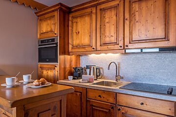 A kitchen with wooden cabinets and a sign that says ' nespresso ' on it