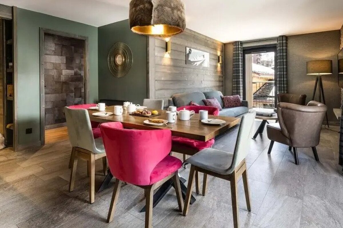 A living room with a dining table and chairs and a couch