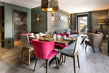 A living room with a dining table and chairs and a couch