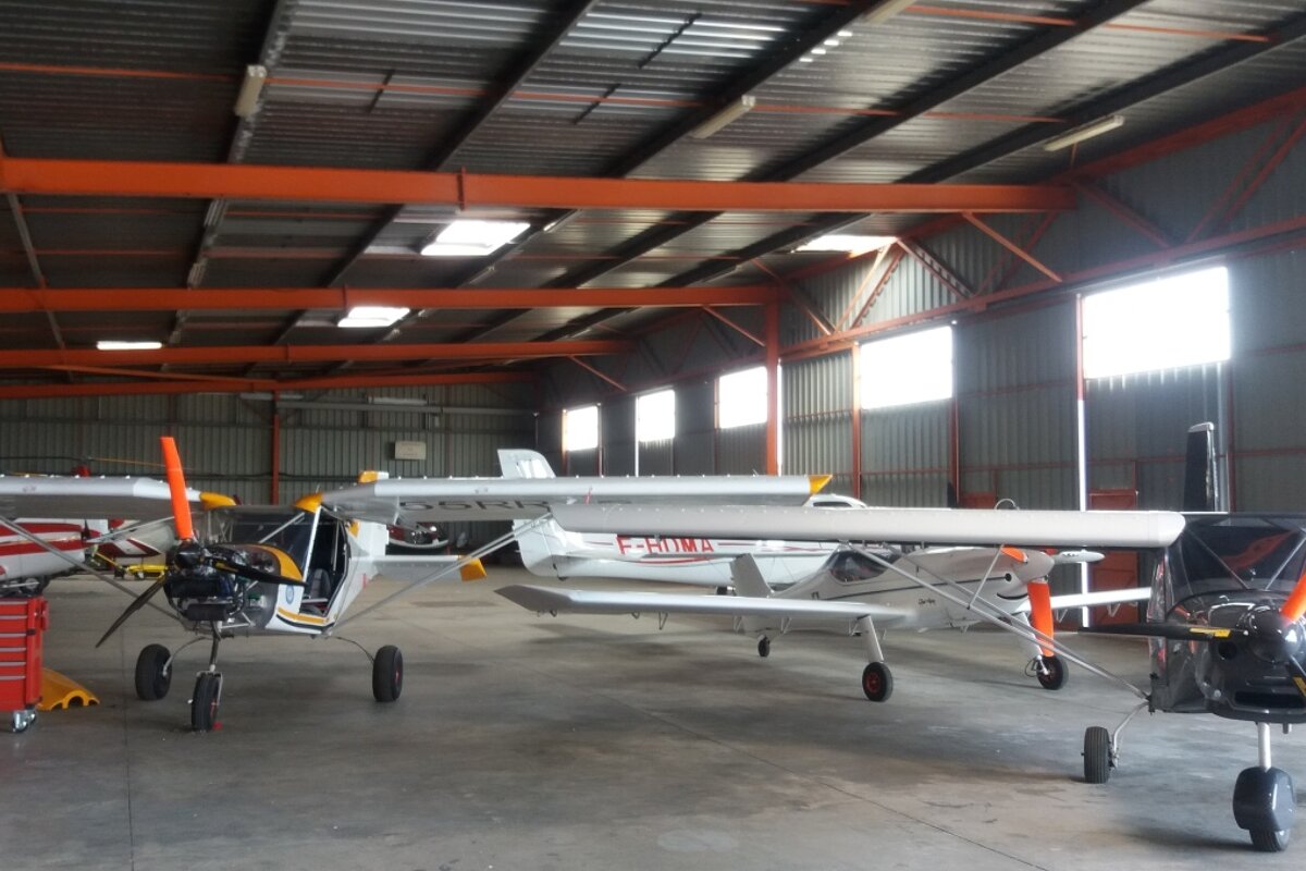 lots of small planes in a hangar