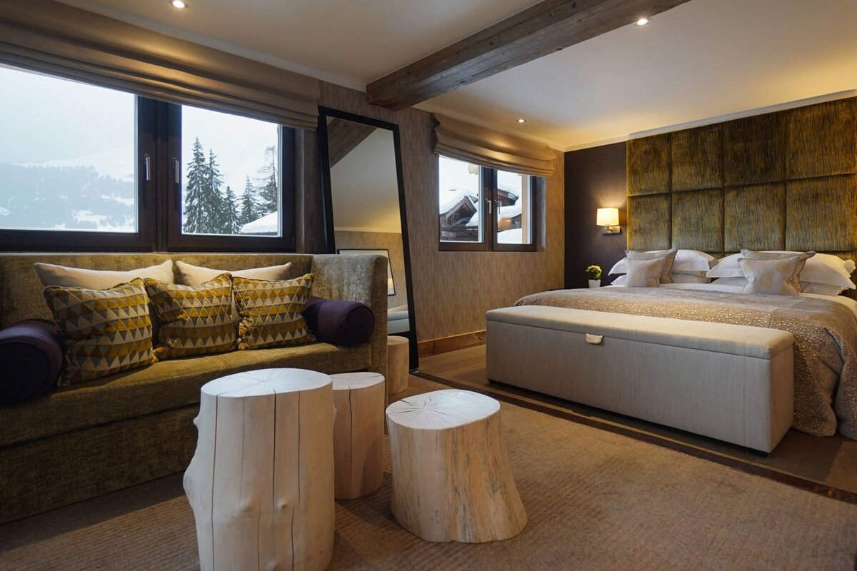 A bedroom with a large bed and a couch