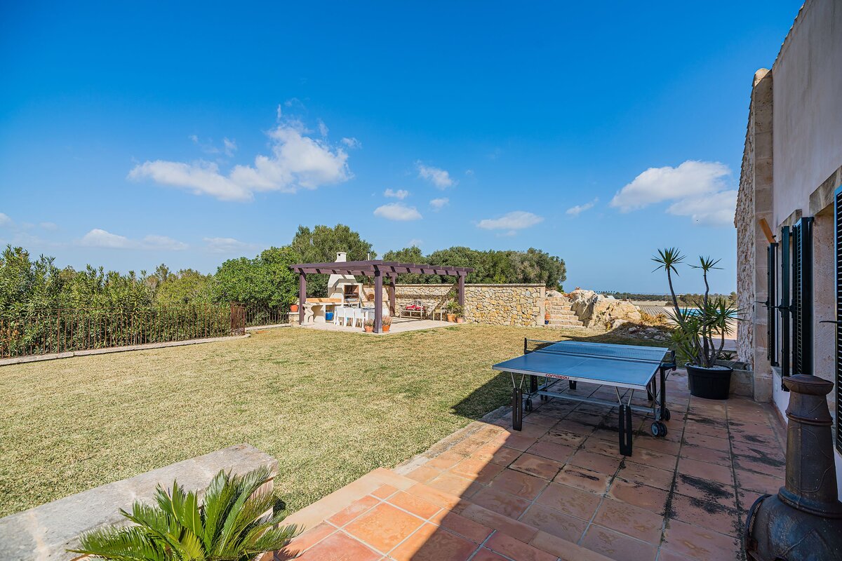 A ping pong table sits in the backyard of a house