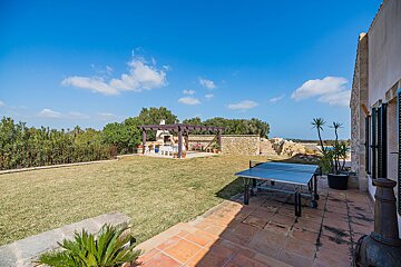 A ping pong table sits in the backyard of a house