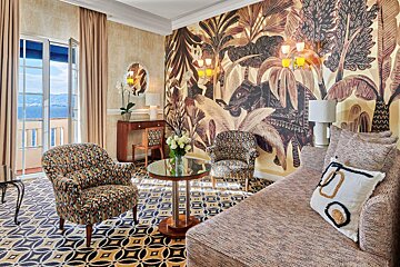 A living room with a couch and two chairs