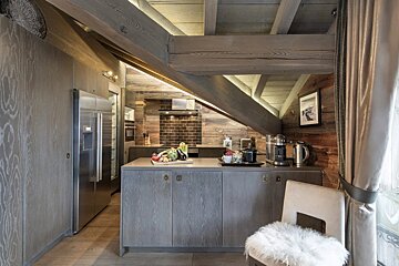 A kitchen with stainless steel appliances and wooden cabinets