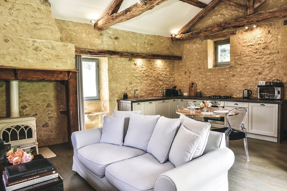 A living room with a white couch and a table