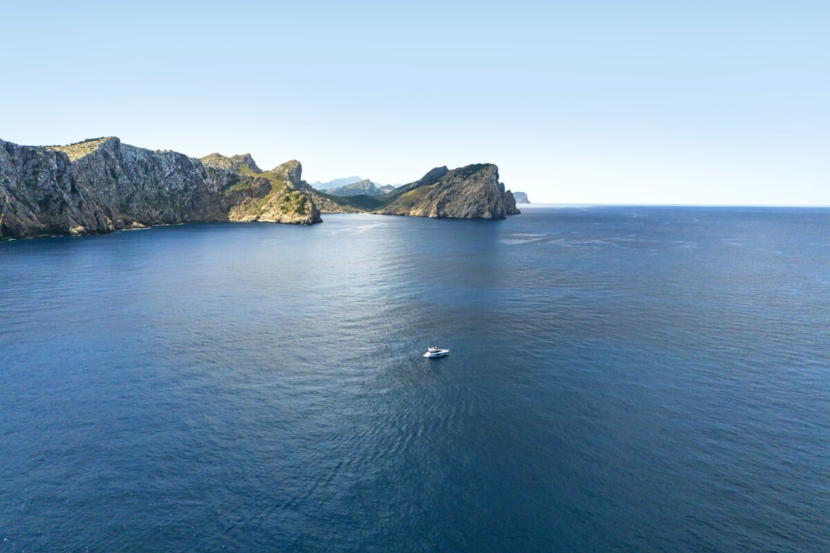 A large body of water with mountains in the background