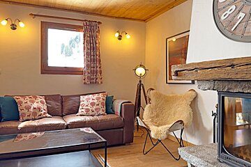 A living room with a couch and a fireplace and a clock with the numbers 878 on it