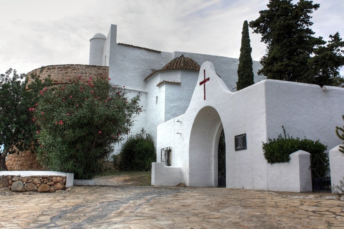 A white building with a red cross on it