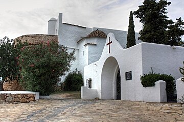 A white building with a red cross on it
