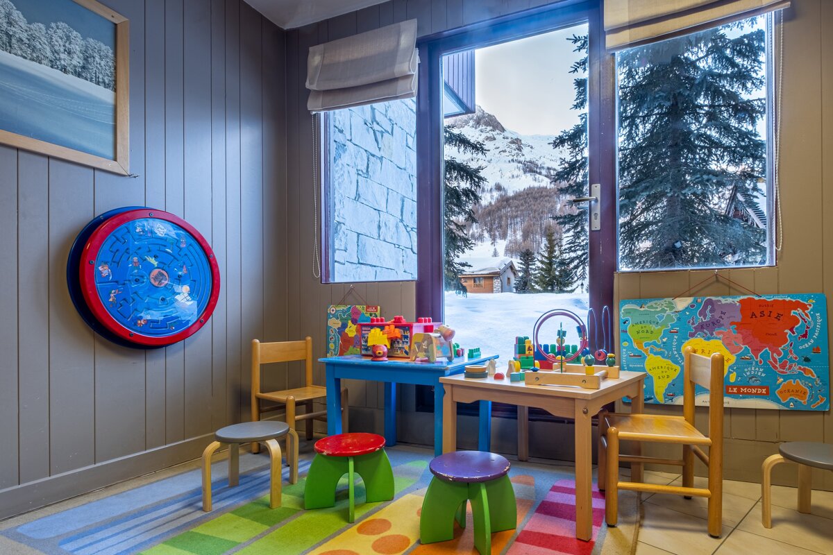 A children 's room with a map of the world hanging on the wall