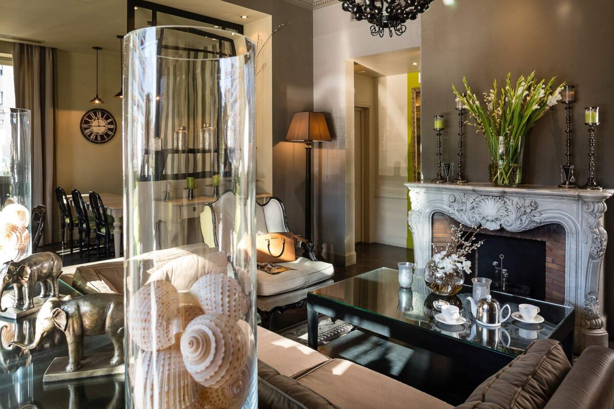 A living room with a fireplace and a clock on the wall