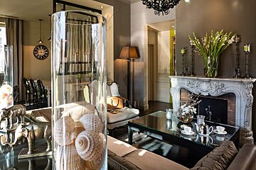 A living room with a fireplace and a clock on the wall