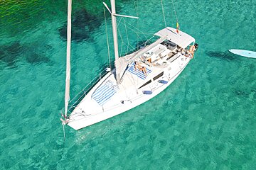 An aerial view of a sailboat in the ocean