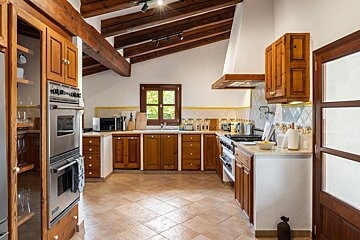 A kitchen with stainless steel appliances and wooden cabinets