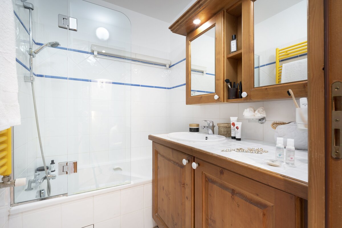 A bathroom with a sink a mirror and a bathtub