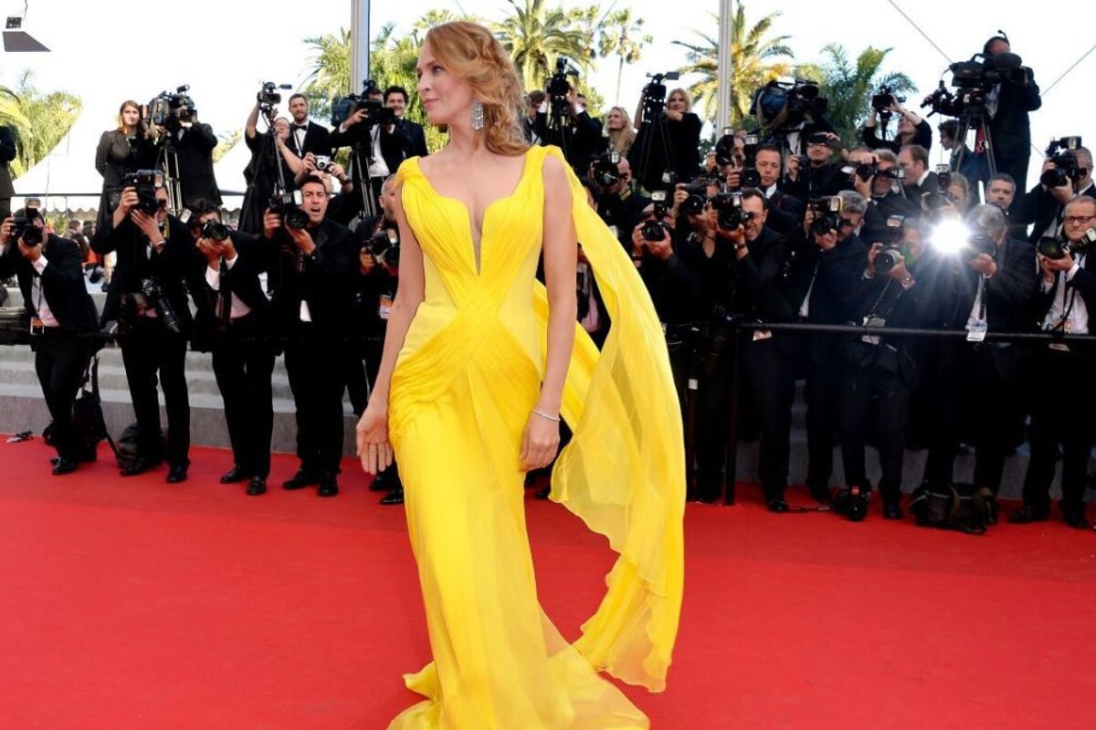 Uma thurman in a yellow dress on the cannes red carpet in 2014