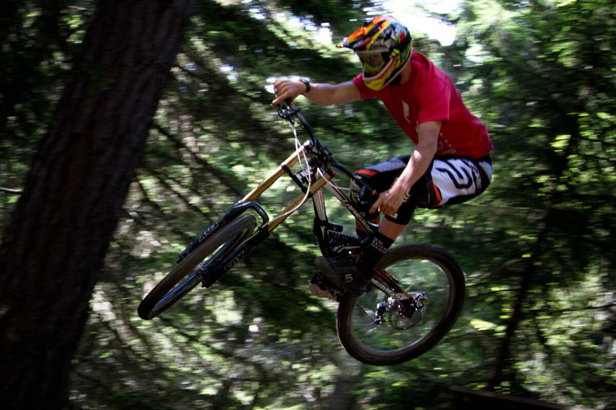 a mountain biker jumping off a trail