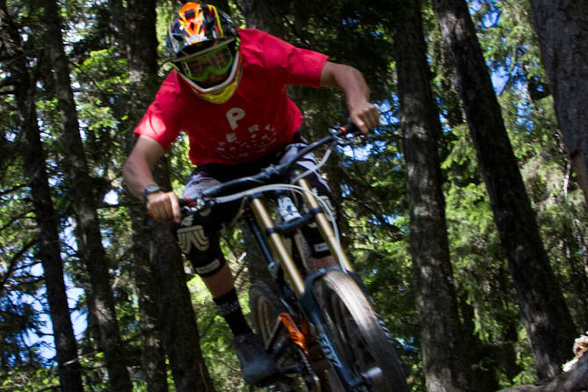 a mountain biker in a red tshirt